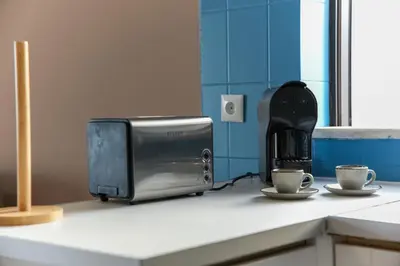 a toaster sitting on a counter next to two cups at Old Town Apartment Panoramic NearThe Beach in Albufeira