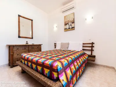 a bedroom with a bed and a dresser and a mirror at Akisol Albufeira Sun in Albufeira