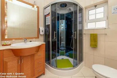 a bathroom with a shower with a toilet and a sink at Akisol Albufeira Sun in Albufeira