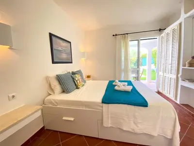 a white bathroom with a sink and a mirror at Albufeira Quinta da Balaia Garden by Homing in Albufeira