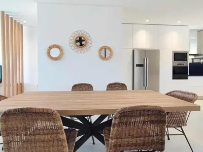 a dining room with a large wooden table and chairs at Vistas Mar Villas D by Stay ici Algarve Holiday Rental in Albufeira