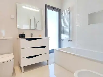a white bathroom with a tub and a sink and a toilet at Vistas Mar Villas D by Stay ici Algarve Holiday Rental in Albufeira
