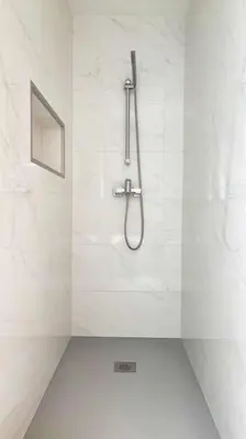 a shower in a bathroom with white tiles at Vistas Mar Villas D by Stay ici Algarve Holiday Rental in Albufeira