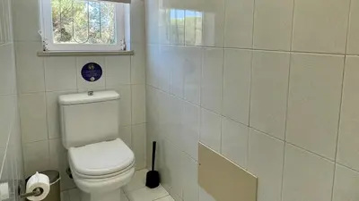 a bathroom with a white toilet and a window at Poço by Check-in Portugal in Albufeira