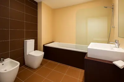 a bathroom with a toilet and a sink and a tub at Votre refuge en bord de mer ! in Albufeira