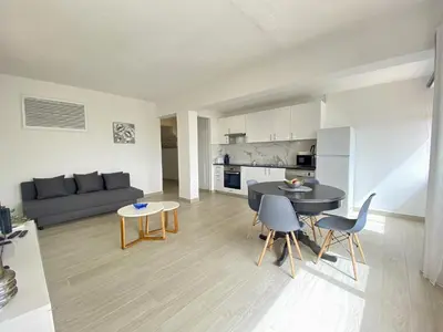 a living room with a couch and a table and chairs at Albufeira Central 6 by Homing in Albufeira