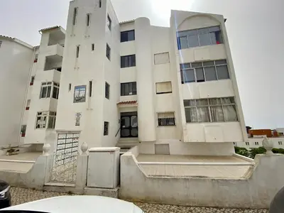 a large white building with a gate in front of it at Albufeira Central 6 by Homing in Albufeira