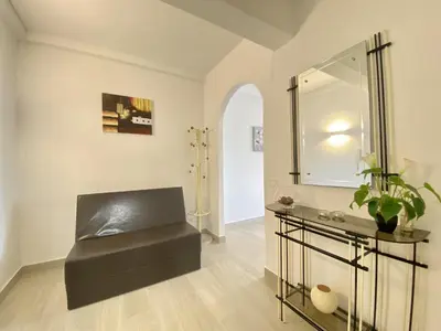 a bathroom with a bench and a mirror and a sink at Albufeira Central 6 by Homing in Albufeira
