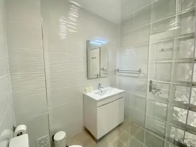 a white bathroom with a sink and a mirror at Albufeira Central 6 by Homing in Albufeira