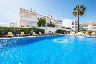 a large swimming pool in front of a building at Martina Apartment - SeaView in Albufeira