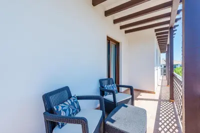 a porch with two chairs and a table at Falesia Beach C in Albufeira