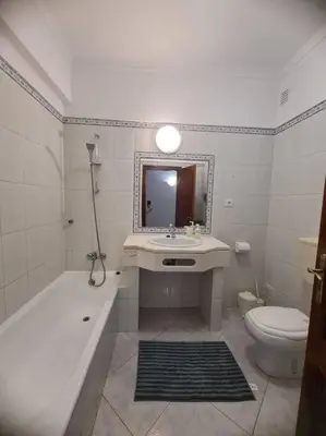 a bathroom with a sink and a tub and a toilet at Cosy & Airy @ Albufeira in Albufeira