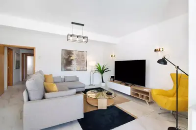 a living room with a couch and a tv at Apartamento W Marina by Sunnyway in Albufeira