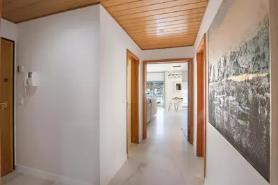 a hallway with white walls and a wooden ceiling at Apartamento W Marina by Sunnyway in Albufeira
