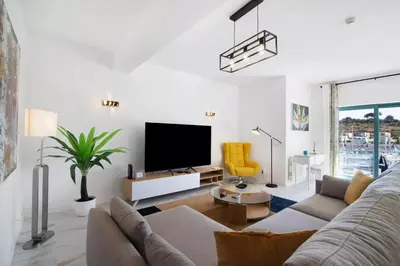 a living room with a couch and a tv at Apartamento W Marina by Sunnyway in Albufeira