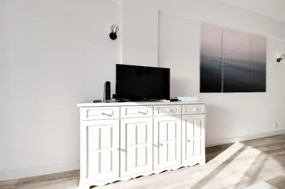a white cabinet with a television on top of it at Renovated Oasis Ocean View 1BD Wi-Fi Beach 3 min in Albufeira