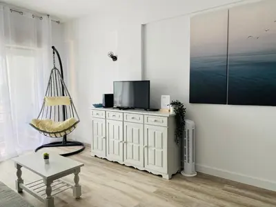a living room with a television and a chair at Renovated Oasis Ocean View 1BD Wi-Fi Beach 3 min in Albufeira