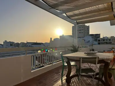 a balcony with a table and a view of a city at Superstar terrace in Faro