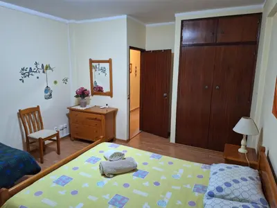 a bedroom with a bed and a desk and a chair at CENTER HOUSE in Faro