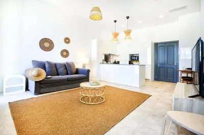 a living room with a couch and a table at Lovely Faro Apartment in Faro