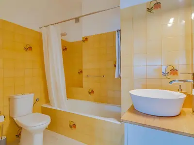 a bathroom with a toilet and a tub and a sink at AL - Apartamento Montemar in Vilamoura