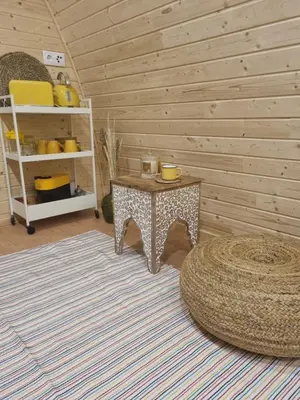 a living room with a table and a shelf at Eco Cabin - Villa das Alfarrobas in Algoz