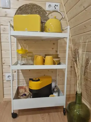 a white shelf with yellow appliances on it at Eco Cabin - Villa das Alfarrobas in Algoz