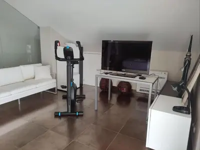 a living room with a flat screen tv and a white couch at Dunas Salgados Apartment by Stay ici Algarve Holiday Rental in Albufeira