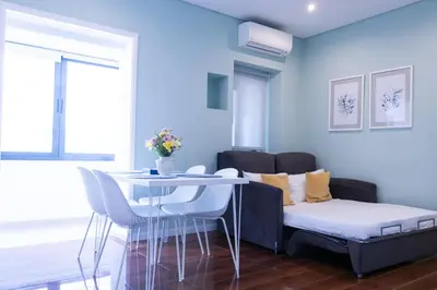 a blue living room with a table and a couch at Mercado Apartments in Faro