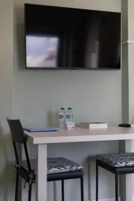 a white table with two chairs and a mirror at Mercado Apartments in Faro