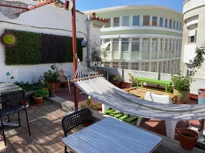a group of tables and chairs on a patio at Faroway Hostel in Faro