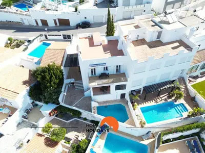 an aerial view of a villa with two swimming pools at #185 V3 Laranjeiras by Home Holidays in Albufeira