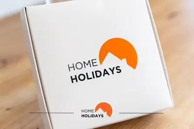 a box with a home holidays sign on a table at #185 V3 Laranjeiras by Home Holidays in Albufeira