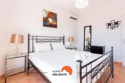 a bedroom with a bed and a tv at #185 V3 Laranjeiras by Home Holidays in Albufeira