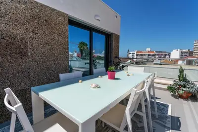 a white table and chairs on the balcony of a house at Diamond Downtown Center in Faro