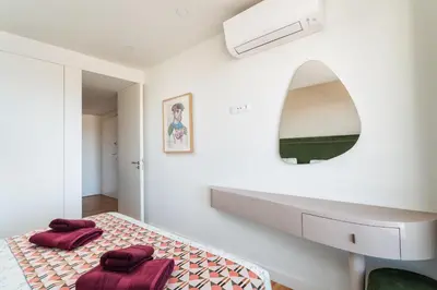 a bedroom with a bed with red pillows on it at Diamond Downtown Center in Faro
