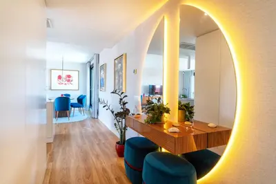 a living room with a table and blue chairs at Diamond Downtown Center in Faro