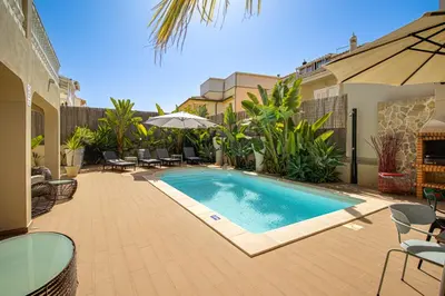 a swimming pool in a yard with chairs and an umbrella at Private Deluxe 3BD Villa Pool Wi-Fi AC BBQ in Albufeira