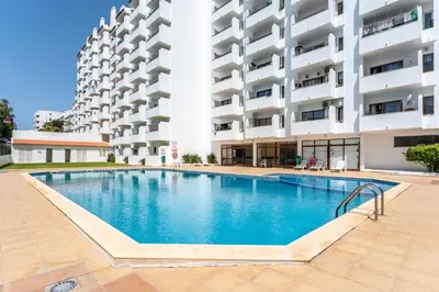 a swimming pool in front of a building at Modern 2 BDR Flat W/Balcony and Pool by LovelyStay in Albufeira
