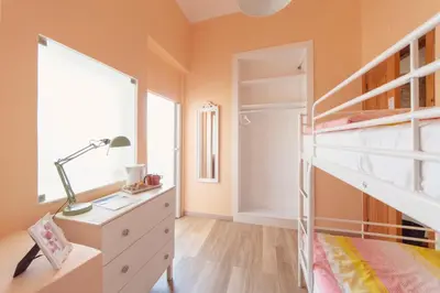a bedroom with a bunk bed and a desk with a lamp at Sunlight House in Faro