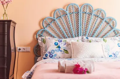 a bed with a blue headboard in a bedroom at Sunlight House in Faro