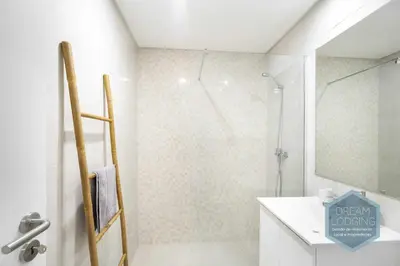 a white bathroom with a shower and a sink at Palm Tree - Dream Lodging in Albufeira