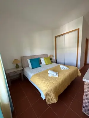 a bedroom with a bed with towels on it at Residence Golf-Vilamoura! in Quarteira