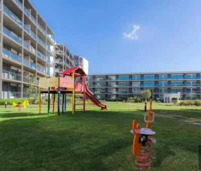 a playground in front of a large building at Residence Golf-Vilamoura! in Quarteira