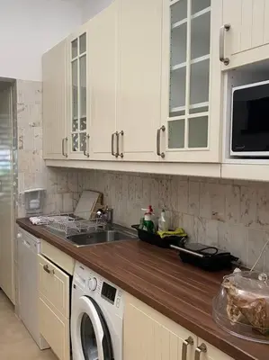 a kitchen with a sink and a washing machine at Casa Calma in Albufeira