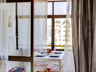 a table in a room with a window at AL - Apartamento Moural in Quarteira