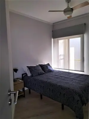 a bedroom with a bed and a window at T2 Requinte e Vista Mar 4 pax in Quarteira