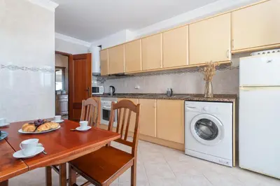 a living room with two chairs and a fireplace at BnB Homes Large fully equipped Apartment with 2 bedrooms, swimming pool & patio in Albufeira