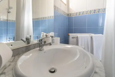 a kitchen with a wooden table and a dining room at BnB Homes Large fully equipped Apartment with 2 bedrooms, swimming pool & patio in Albufeira