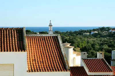 a view of roofs of buildings with a clock tower at Apartamento Turistico Silva in Albufeira